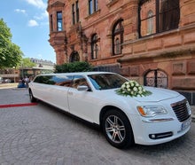Stretchlimousine mit rotem Teppich als Hochzeitsfahrzeug